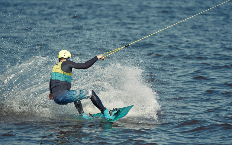 Man wakeboarding on open water in Southeast Asia.